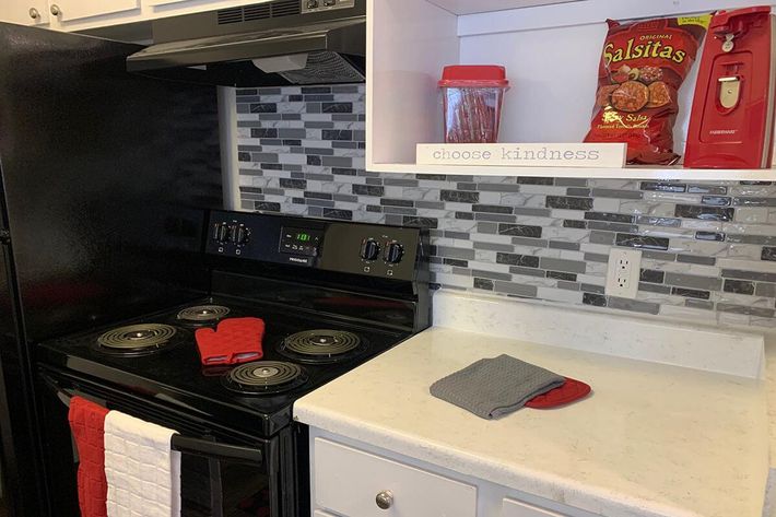a stove top oven sitting inside of a kitchen counter