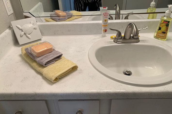 a counter with a sink and a mirror