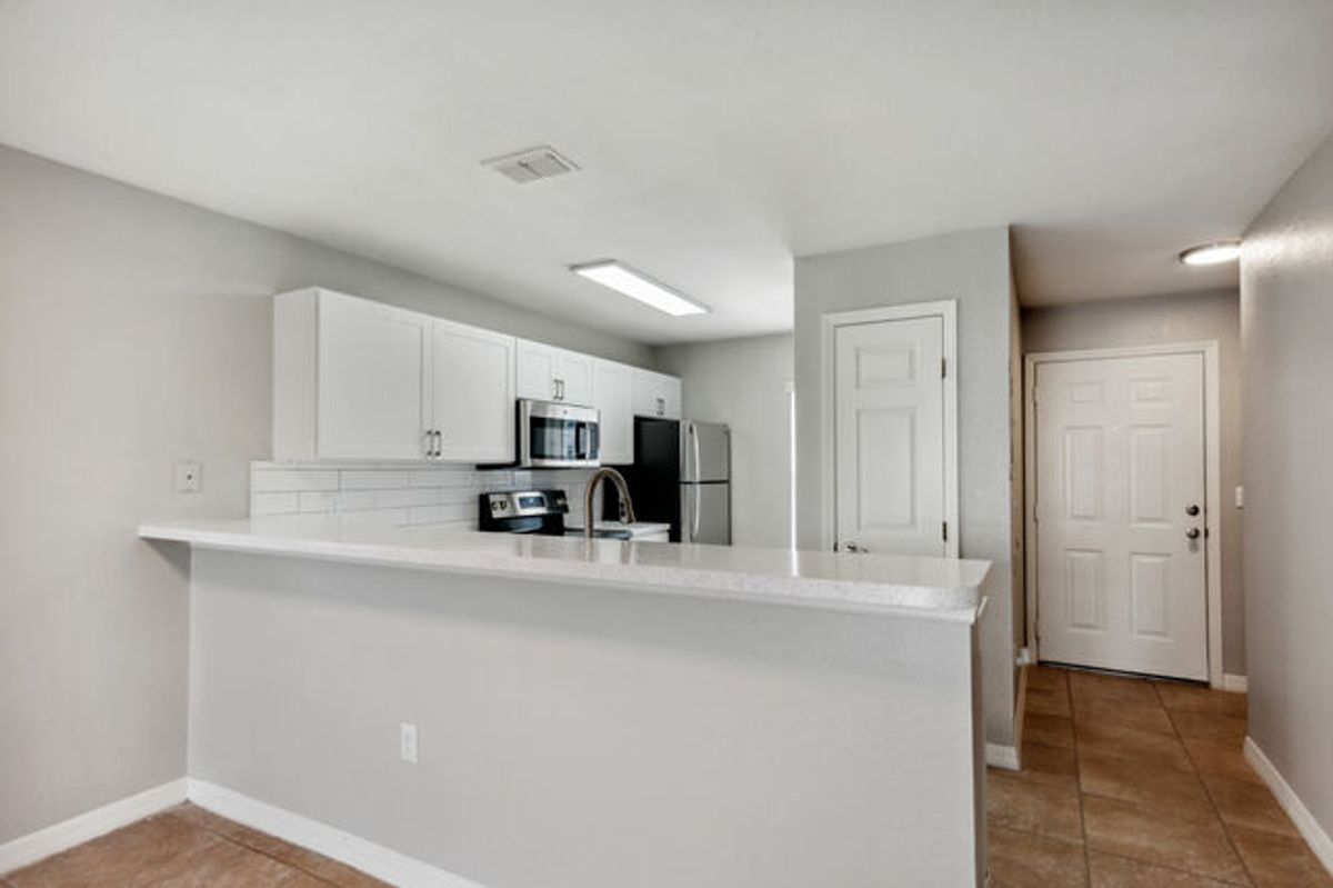 White Cabinets with Terracotta Tiled Floors