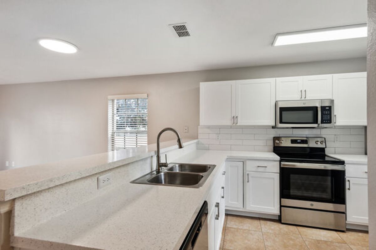 White Cabinets with Terracotta Tiled Floors