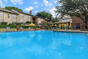community pool with yellow umbrellas