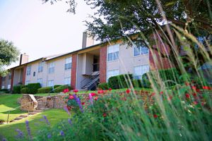 community building with red and purple flowers