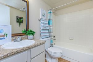 a bathroom with white cabinets