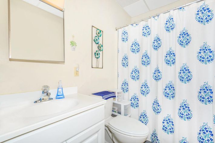 a white sink and shower curtain