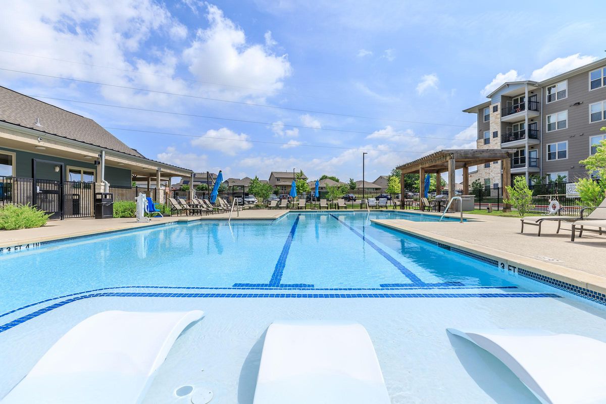 Dog-Friendly Apartments in Pflugerville TX - Legacy Ranch at Dessau East - Spacious Pool Surrounded by Lounge Seating