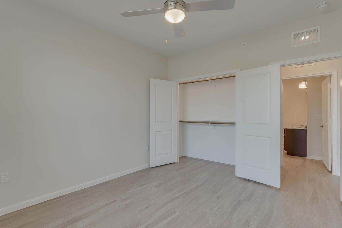 Apartments for Rent Pflugerville - Legacy Ranch at Dessau East Spacious Bedroom with a Expansive Closet, Wood-Style Flooring, and Many More Great Bedroom Amenities