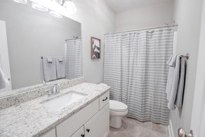 a bedroom with a shower and a sink