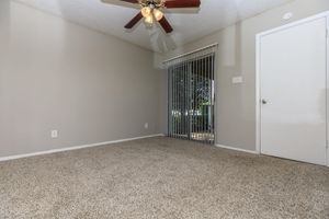 carpeted room with a ceiling fan