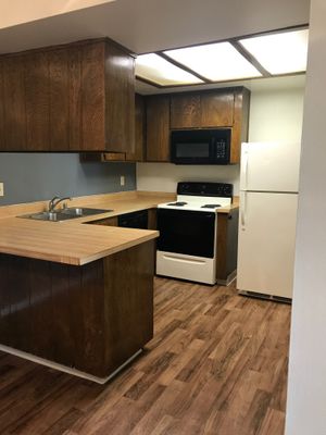 Vacant kitchen with wooden floors
