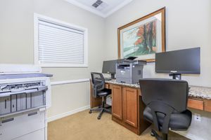 a home office with a desk and chair in a room