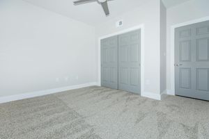 PLUSH CARPETS AND CEILING FANS IN BEDROOM