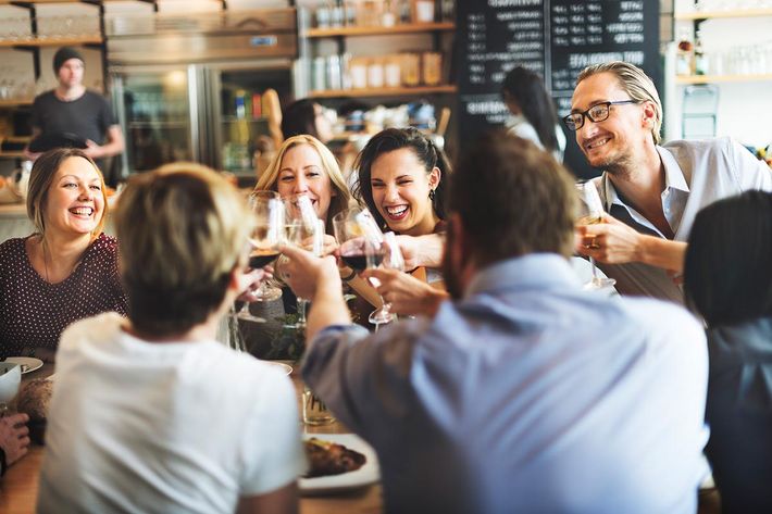 a group of people drinking wine at a restaurant