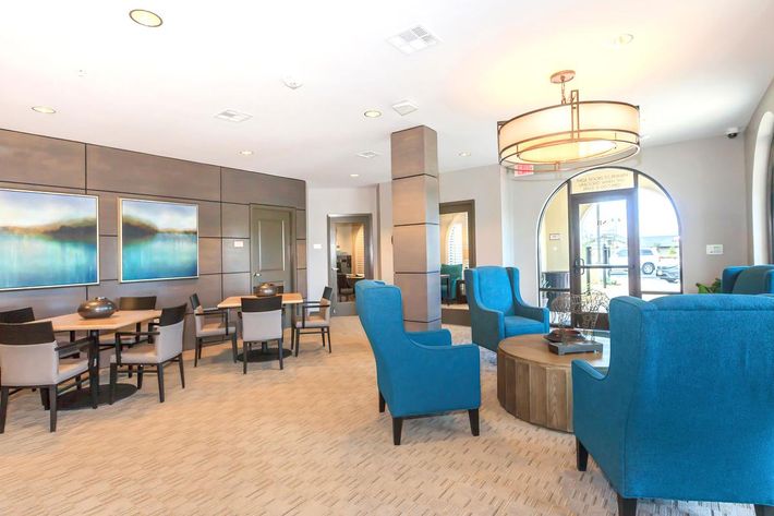 Sendero Bluffs Senior Apartments community room with blue chairs