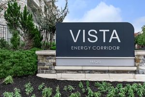 Vista Energy Corridor monument sign with green plants