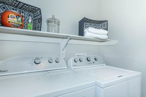 furnished laundry closet with washer and dryer