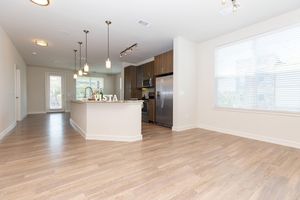 unfurnished dining room and kitchen with wooden floors