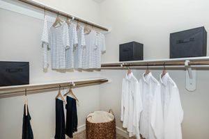 walk-in closet with clothes