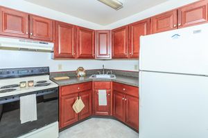 a kitchen with a red refrigerator and a stove