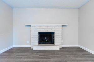 White brick fireplace with mantel above
