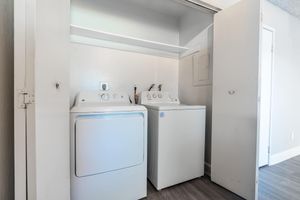 Large washer and drier tucked in closet with sliding doors