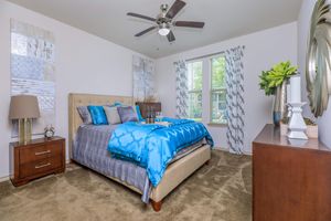 carpeted bedroom with blue comforters