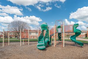 a playground in front of a green field