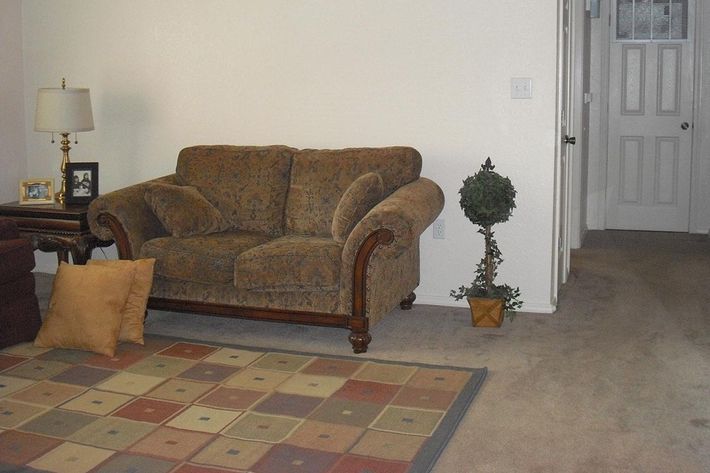 a living room filled with furniture and a rug