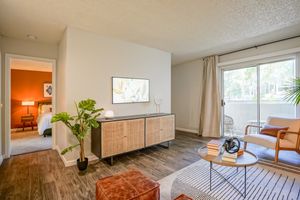 Wall-mounted TV in furnished platinum living room interior at Treehouse in Albuquerque, New Mexico