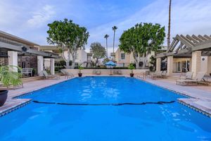 Regency Plaza Apartment Homes community pool with green trees