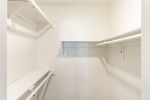 Inside a walk in closet with built in shelving
