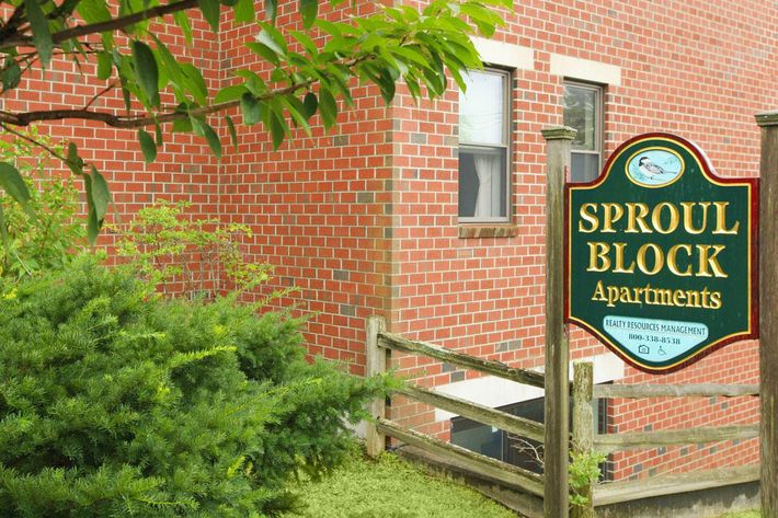 a sign in front of a brick building