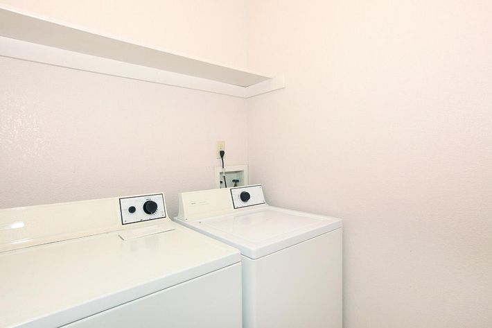 a white sink sitting under a microwave