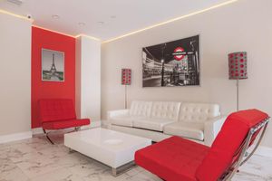 a living area with red and white furniture