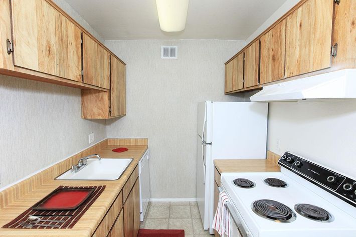 a kitchen with a stove top oven sitting inside of a refrigerator
