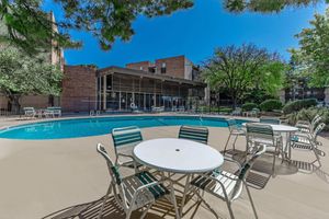 Villa Apartments community pool with tables and chairs