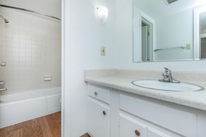 bathroom with white cabinets
