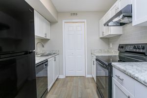 KITCHEN WITH STAINLESS APPLIANCES AND DISHWASHER