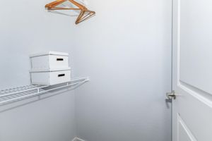 a white refrigerator freezer sitting next to a shower