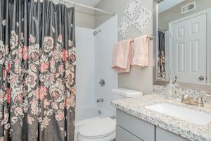 a shower curtain next to a sink