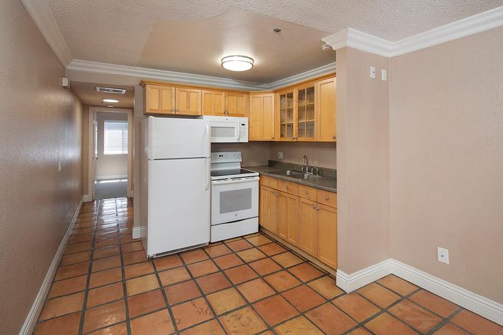 a kitchen with a tiled floor