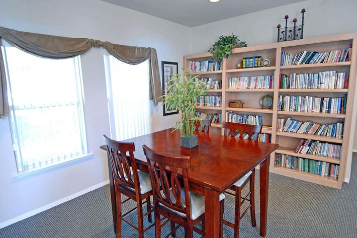a dining room table and chairs in a library