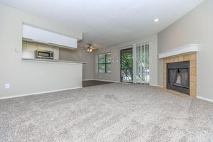 carpeted living room with a fireplace