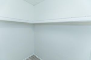 Walk in closet space with built in shelving