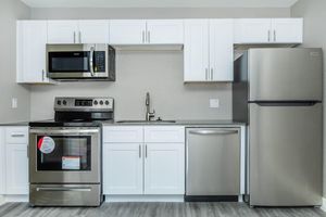 Brand new modern kitchen with stainless steel appliances and white shaker cabinets