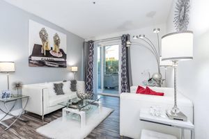 a living room filled with furniture and a mirror