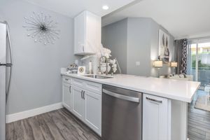 a kitchen with a sink and a mirror