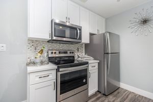 a stove top oven sitting inside of a kitchen