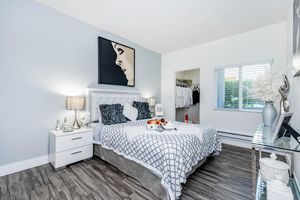 a bedroom with a bed and a mirror in a room