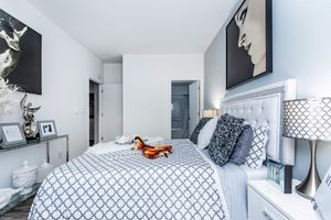 a bedroom with a bed in a room