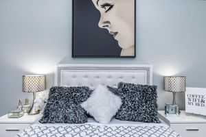 a bedroom with a bed and a mirror